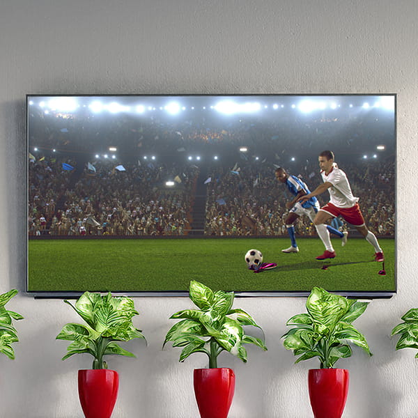 Customer relaxing with free WiFi and TV at Legacy Laundry Plainfield